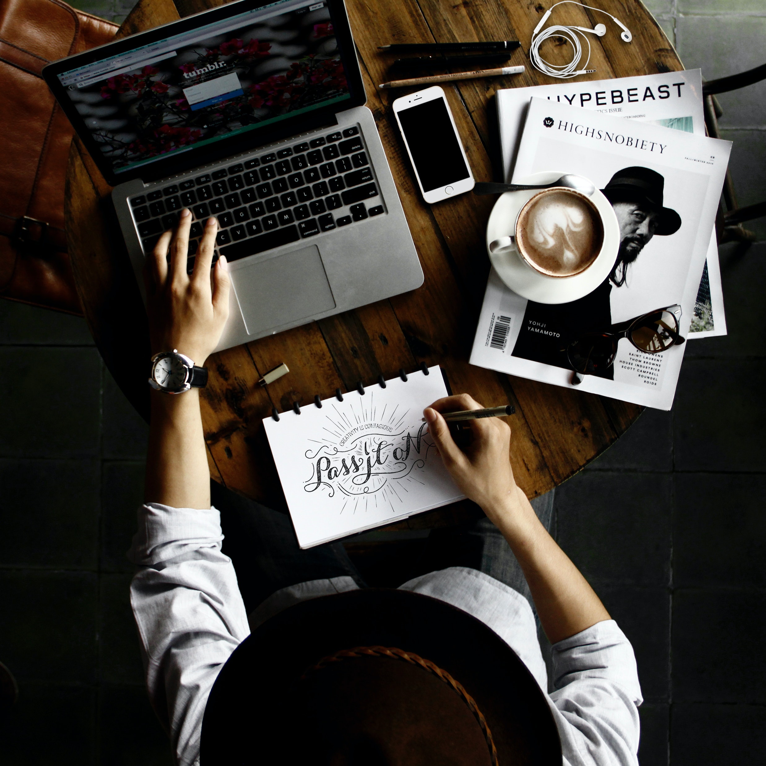 Man working on computer and writing on a notebook